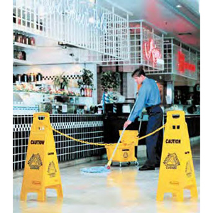 Rubbermaid FG611477 yellow 4-sided wet floor sign in use
